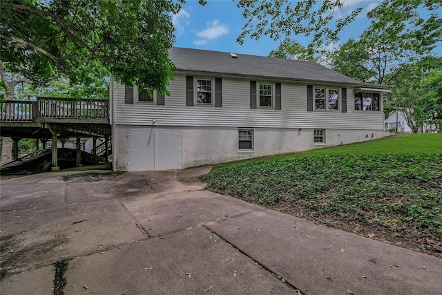 56 Locust Dr, Rocky Point, NY 11778 - view of side of home with a wooden deck, a lawn, and concrete driveway