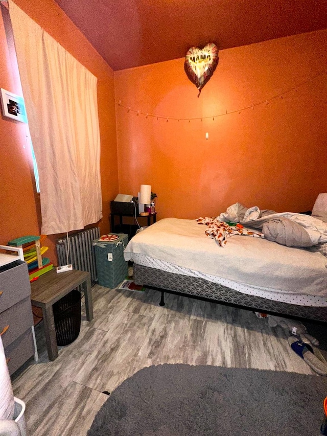 110 Beech St, Yonkers, NY 10701 - bedroom with wood finished floors and radiator heating unit