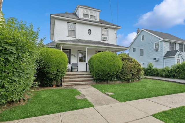 45 Crosby Ave, Albertson, NY 11507 - traditional style home with a porch, a front yard, stucco siding, and cooling unit
