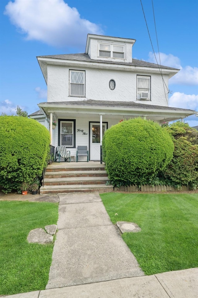 45 Crosby Ave, Albertson, NY 11507 - traditional style home featuring a porch, a front lawn, and stucco siding