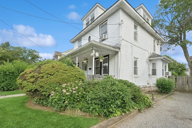 45 Crosby Ave, Albertson, NY 11507 - view of side of property with covered porch, stucco siding, and cooling unit