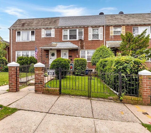 200-06 39th Ave, Bayside, NY 11361 - view of front of property with a shingled roof, a fenced front yard, and brick siding
