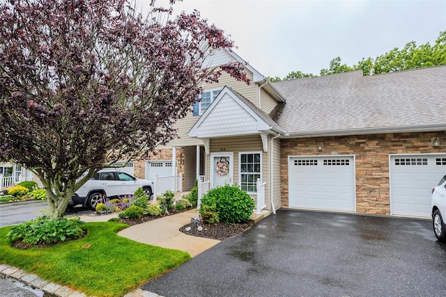 164 Ira Rd, Mount Sinai, NY 11766 - multi unit property featuring stone siding, asphalt driveway, a garage, and a shingled roof