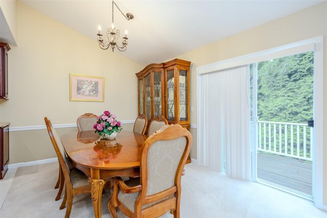 164 Ira Rd, Mount Sinai, NY 11766 - dining room with a chandelier, vaulted ceiling, and light colored carpet