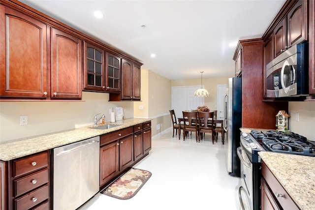 164 Ira Rd, Mount Sinai, NY 11766 - kitchen featuring stainless steel appliances, glass insert cabinets, hanging light fixtures, light stone countertops, and recessed lighting