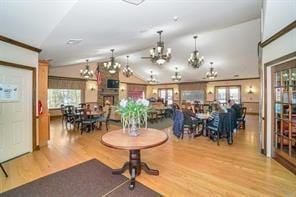 164 Ira Rd, Mount Sinai, NY 11766 - dining area featuring wood finished floors, lofted ceiling, and a chandelier