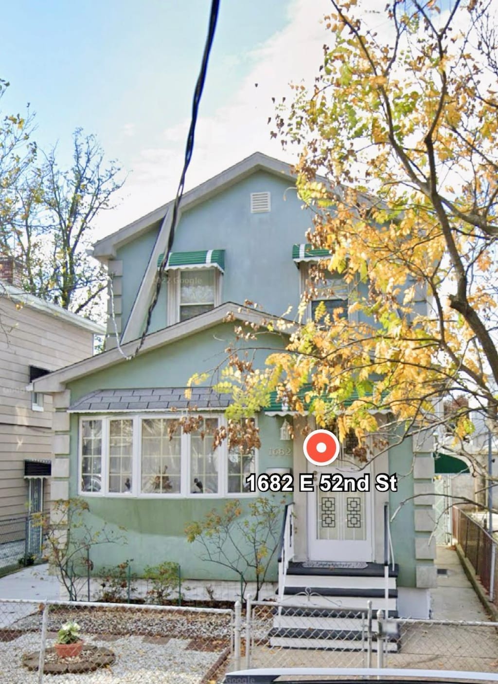 1682 E 52nd St, Brooklyn, NY 11234 - view of front of home featuring stucco siding and a fenced front yard