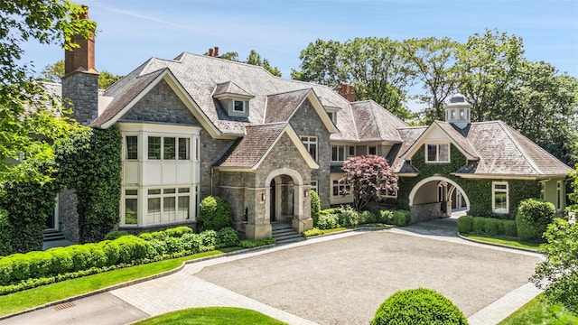 3 Terrace Cir, Armonk, NY 10504 - view of front of house featuring stone siding, a high end roof, and a chimney