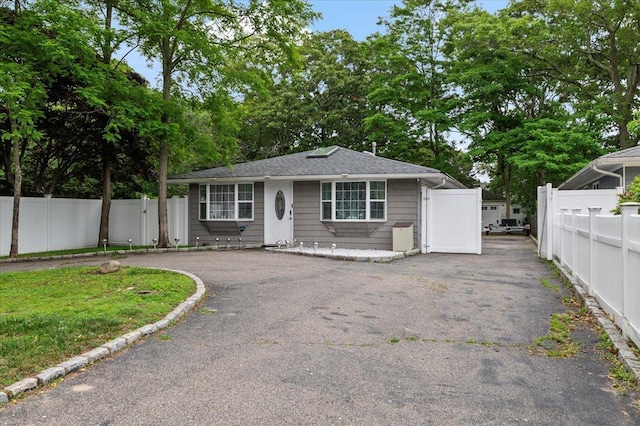 7 Pine Tree Dr, Shirley, NY 11967 - view of front of home featuring asphalt driveway and roof with shingles