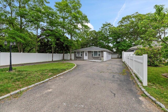 7 Pine Tree Dr, Shirley, NY 11967 - view of front of house with asphalt driveway and a garage