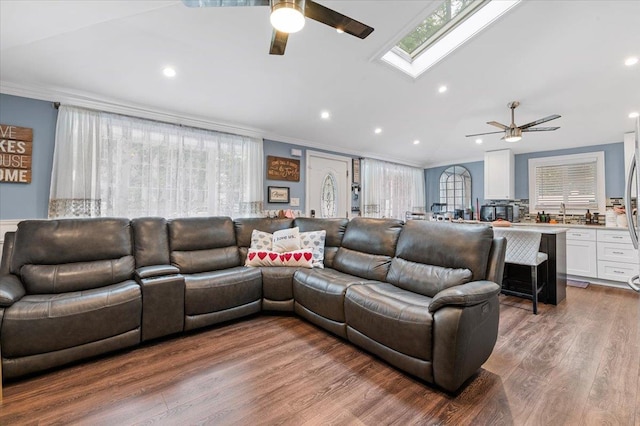 7 Pine Tree Dr, Shirley, NY 11967 - living room with a ceiling fan, crown molding, a skylight, wood finished floors, and plenty of natural light