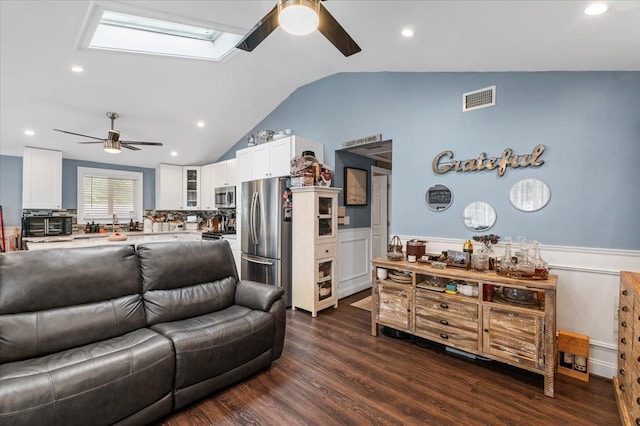 7 Pine Tree Dr, Shirley, NY 11967 - living room featuring ceiling fan, a wainscoted wall, lofted ceiling, a skylight, and dark wood-style flooring