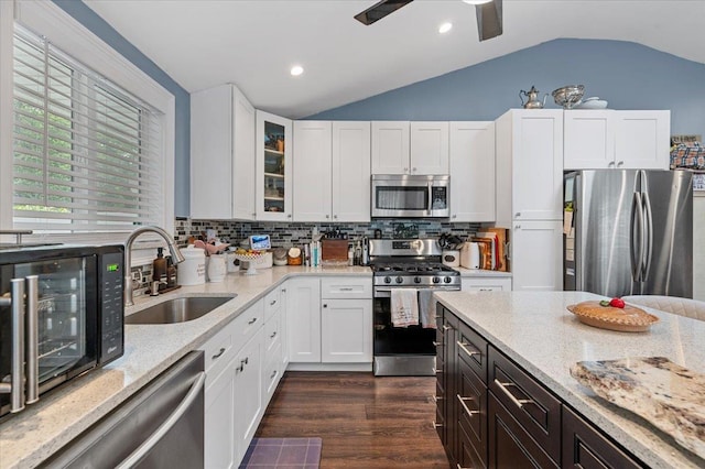 7 Pine Tree Dr, Shirley, NY 11967 - kitchen with stainless steel appliances, vaulted ceiling, light stone countertops, white cabinetry, and recessed lighting