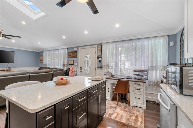 7 Pine Tree Dr, Shirley, NY 11967 - kitchen featuring a ceiling fan, crown molding, dark wood-style floors, a skylight, and lofted ceiling