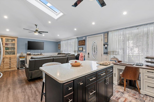 7 Pine Tree Dr, Shirley, NY 11967 - kitchen featuring a ceiling fan, ornamental molding, vaulted ceiling, a kitchen breakfast bar, and dark cabinets