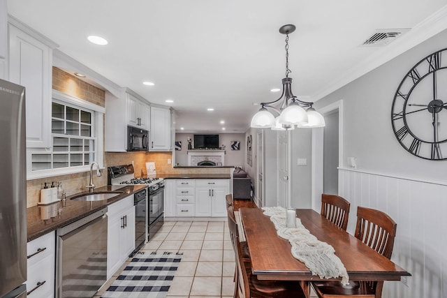15 Format Ln, Smithtown, NY 11787 - kitchen featuring black appliances, decorative backsplash, white cabinets, light tile patterned floors, and a peninsula