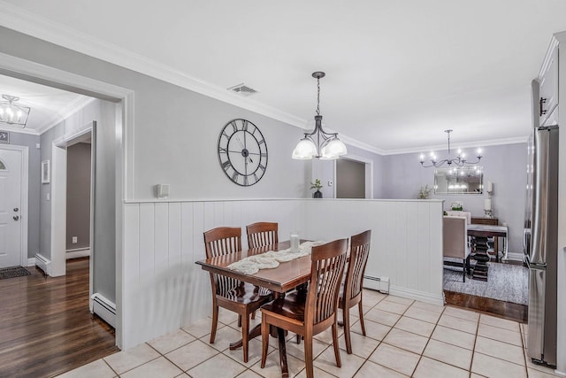 15 Format Ln, Smithtown, NY 11787 - dining area featuring a chandelier, ornamental molding, baseboard heating, a baseboard heating unit, and light wood finished floors