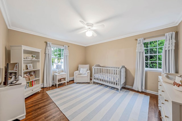 15 Format Ln, Smithtown, NY 11787 - bedroom featuring crown molding, dark wood-style floors, a crib, baseboard heating, and ceiling fan