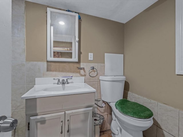 11416 121st St, South Ozone Park, NY 11420 - half bath with tile walls, vanity, a wainscoted wall, and tile patterned flooring