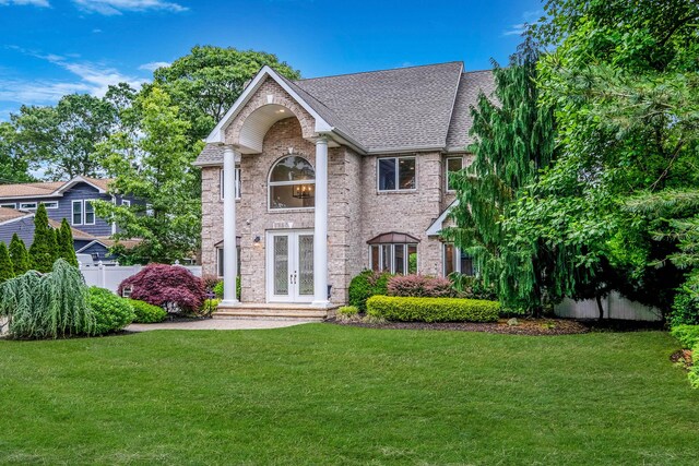 53 Pequot Ln, East Islip, NY 11730 - neoclassical home with french doors, brick siding, and roof with shingles