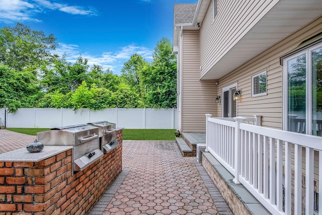 53 Pequot Ln, East Islip, NY 11730 - fenced backyard featuring an outdoor kitchen, a patio, and a deck