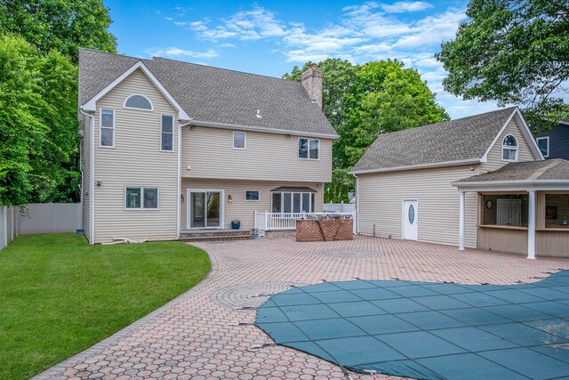 53 Pequot Ln, East Islip, NY 11730 - rear view of property with a chimney, a patio area, and a shingled roof