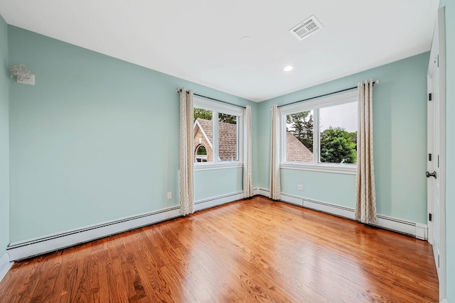 53 Pequot Ln, East Islip, NY 11730 - spare room with wood finished floors, a baseboard radiator, and recessed lighting