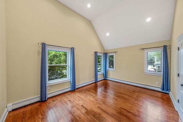 53 Pequot Ln, East Islip, NY 11730 - empty room featuring a baseboard radiator, wood finished floors, recessed lighting, and high vaulted ceiling