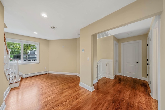 53 Pequot Ln, East Islip, NY 11730 - unfurnished room with baseboard heating, light wood finished floors, and recessed lighting