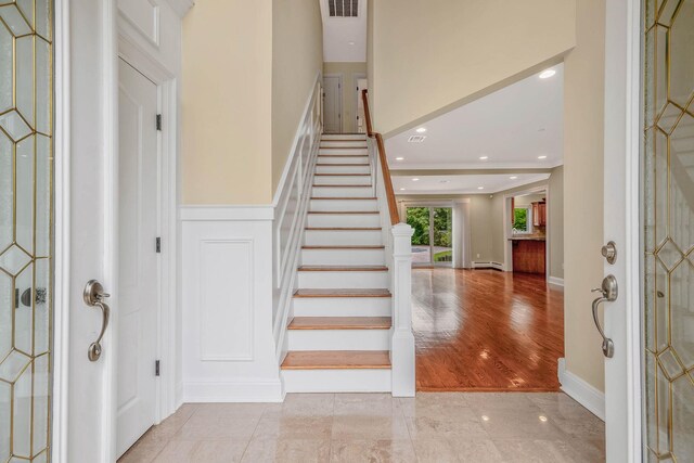 53 Pequot Ln, East Islip, NY 11730 - foyer featuring stairs, wainscoting, recessed lighting, and a decorative wall