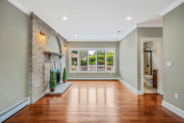 53 Pequot Ln, East Islip, NY 11730 - unfurnished living room featuring a baseboard radiator, a baseboard heating unit, wood finished floors, a fireplace, and crown molding