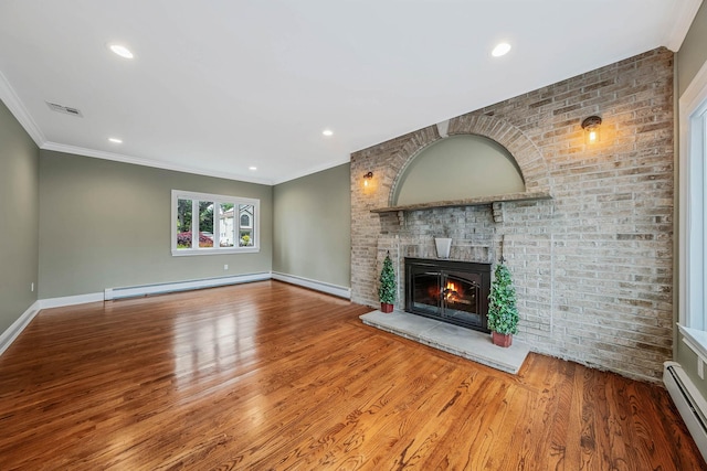53 Pequot Ln, East Islip, NY 11730 - unfurnished living room featuring a baseboard radiator, wood finished floors, a fireplace, ornamental molding, and recessed lighting