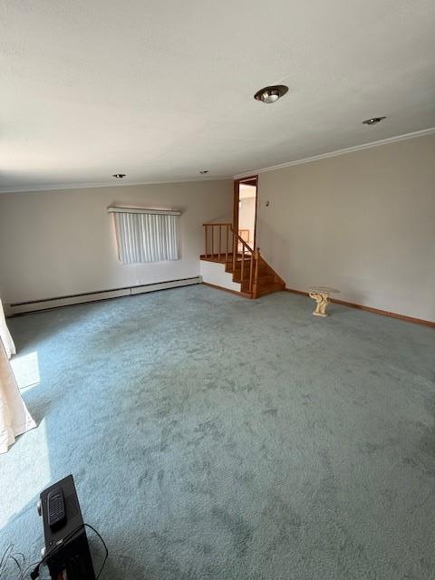109 Nassau Dr, Albertson, NY 11507 - carpeted empty room featuring a baseboard radiator, crown molding, and stairs