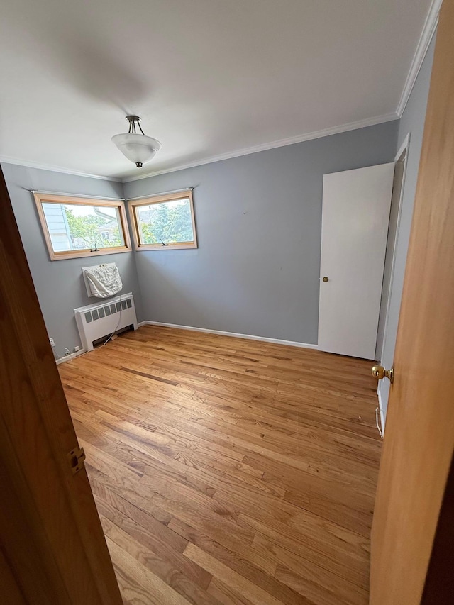 109 Nassau Dr, Albertson, NY 11507 - spare room featuring radiator, crown molding, and wood finished floors