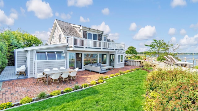 12910 Main Rd, East Marion, NY 11939 - back of house with a patio, an outdoor hangout area, a yard, a water view, and outdoor dining area