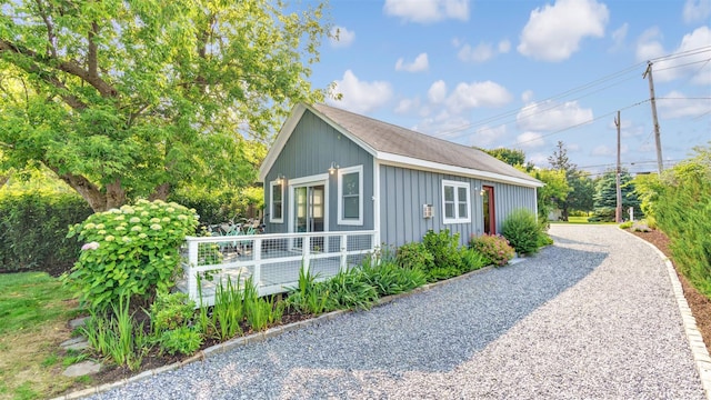 12910 Main Rd, East Marion, NY 11939 - view of side of property featuring board and batten siding, a deck, and driveway