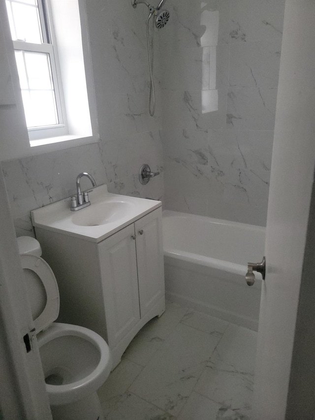 88-11 Elmhurst Ave Unit D15, Elmhurst, NY 11373 - bathroom featuring washtub / shower combination, marble look tiles, and vanity