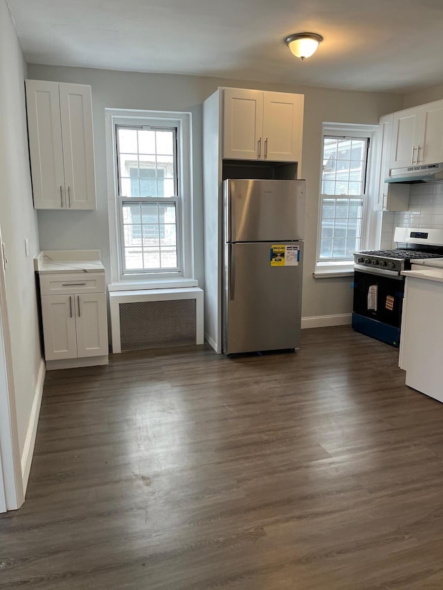 88-11 Elmhurst Ave Unit D15, Elmhurst, NY 11373 - kitchen with appliances with stainless steel finishes, radiator, under cabinet range hood, and white cabinetry