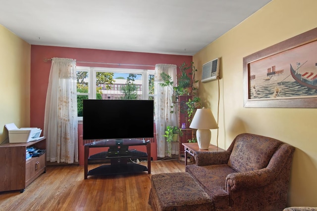 2088 Virgil Pl, Bronx, NY 10473 - living area with a wall mounted air conditioner and light wood-style flooring