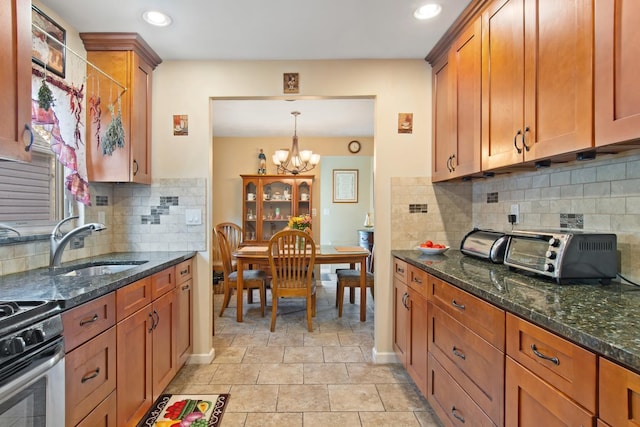 2088 Virgil Pl, Bronx, NY 10473 - kitchen with a chandelier, brown cabinets, dark stone countertops, recessed lighting, and backsplash