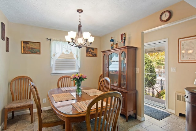 2088 Virgil Pl, Bronx, NY 10473 - dining room with a chandelier, radiator, and a textured ceiling
