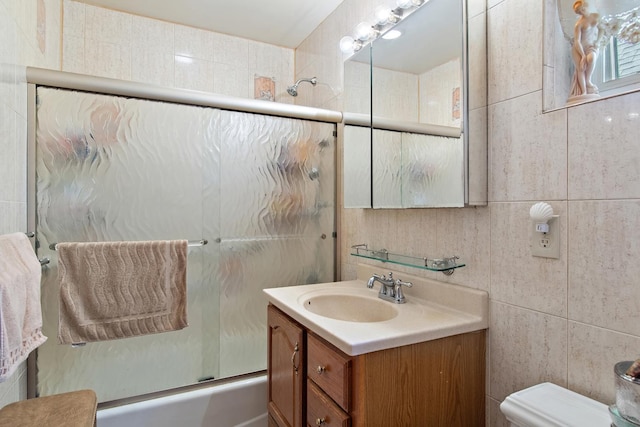 2088 Virgil Pl, Bronx, NY 10473 - bathroom featuring vanity, combined bath / shower with glass door, and tile walls