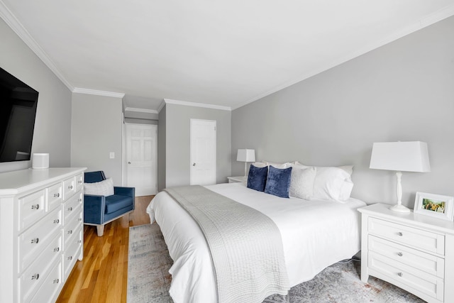 5 Birchwood Ct Unit 2C, Mineola, NY 11501 - bedroom featuring light wood-style floors, crown molding, and a closet