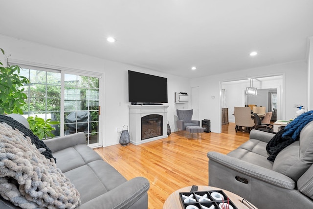 17 Sachem St, East Rockaway, NY 11518 - living room with wood finished floors, recessed lighting, and a glass covered fireplace