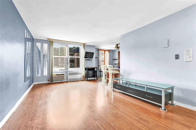 68-15 Selfridge St Unit 5D, Forest Hills, NY 11375 - empty room with radiator heating unit, wood finished floors, and a wall mounted AC