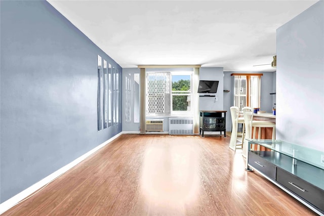 68-15 Selfridge St Unit 5D, Forest Hills, NY 11375 - unfurnished living room with radiator and wood finished floors