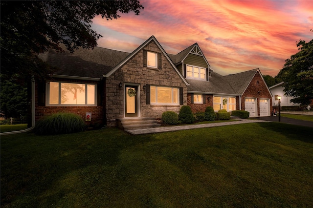 85 Jay St, Stony Point, NY 10980 - view of front of house with concrete driveway, a yard, stone siding, a garage, and roof with shingles