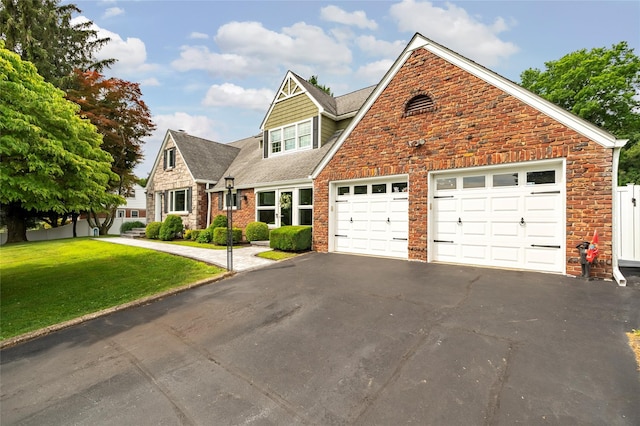 85 Jay St, Stony Point, NY 10980 - view of front of home with driveway, an attached garage, a front lawn, and stone siding