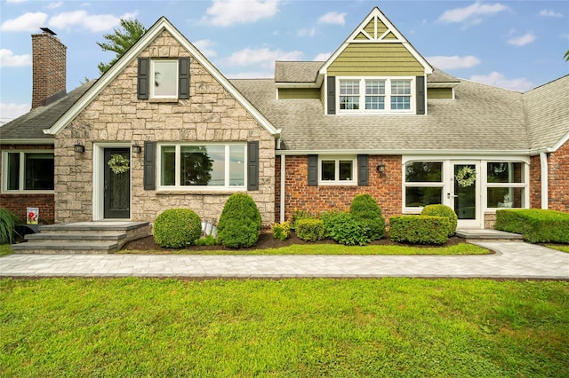 85 Jay St, Stony Point, NY 10980 - view of front of house with roof with shingles, a chimney, a front lawn, and stone siding