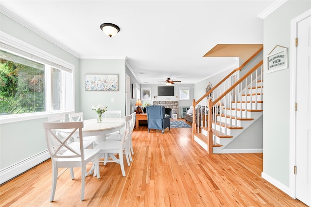 85 Jay St, Stony Point, NY 10980 - dining area with a stone fireplace, crown molding, ceiling fan, plenty of natural light, and stairs